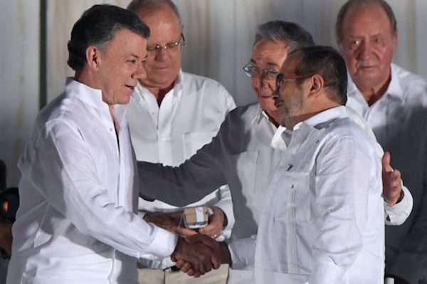  FARC leader Timochenko  and Colombia President Santos shake hands at the Peace agreement ceremony in Cuba in Sept. 2016 