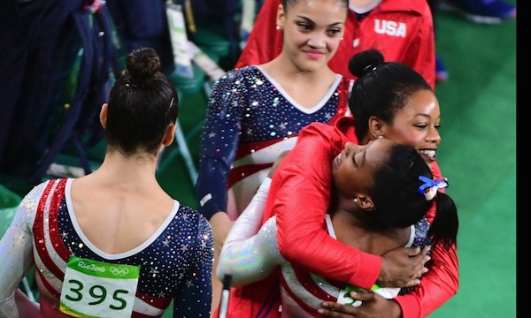 US Women Gymnastics team members Simone Biles, Gabby Douglas, Aly Raisman, Laurie Hernandez and Madison Kocian congratulate each other on winning the gold